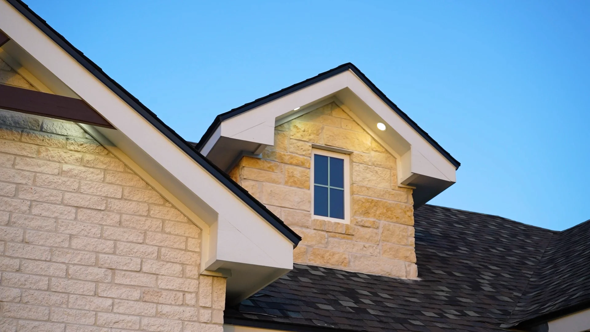 Stone gable and dormer detail on a custom home built by Go To Guys RGV